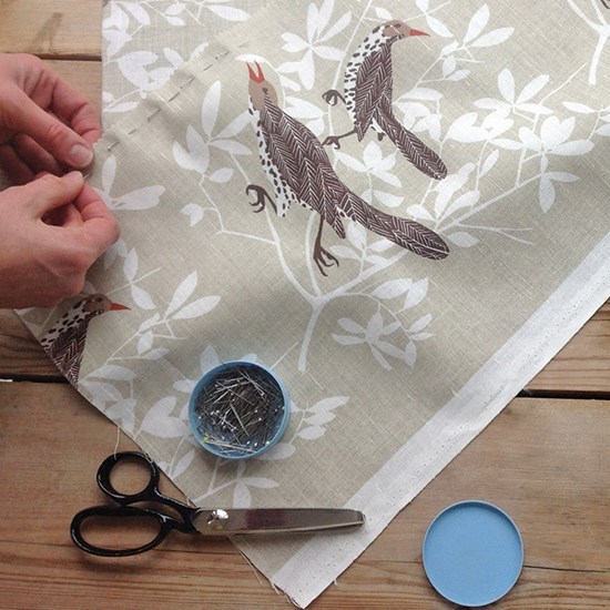 duett cotton/linen fabric in beige by David van Berckel showing two thrushes singing in a tree duett cotton/linen fabric in beige by David van Berckel showing two thrushes singing in a tree