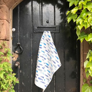 against the flow blue fish tea towel against the flow tea towel