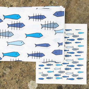 against the flow tea towel and sponge cloth in blue against the flow tea towel