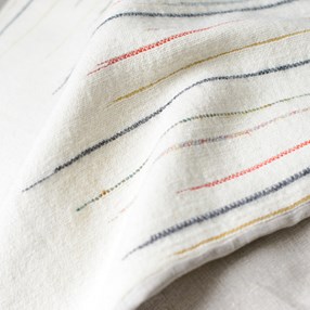 Chalkney stripe Throw in Ecru slub effect striped woven throw by Laura Fletcher in multi colour on off-white ecru ground