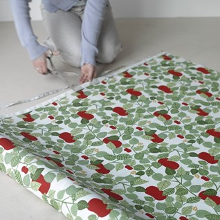 red orchard cotton print is a fresh design featuring red apples and green leaves for drapes