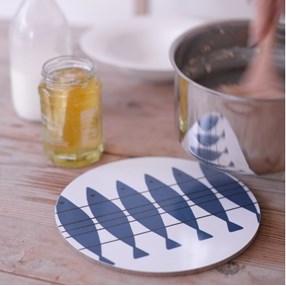 blue and white heat proof kitchen trivet of vintage fish design