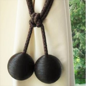 brown leather ball curtain tieback or hold-back in a window leather ball tiebacks - brown