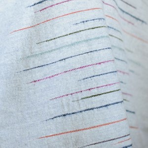 slub effect striped woven throw by Laura Fletcher in multi colour on soft grey ground Chalkney stripe throw Soft Grey
