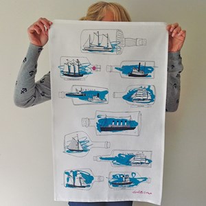 blue kitchen tea towel by illustrator charlotte farmer with blue ships-in-bottle ship ahoy tea towel