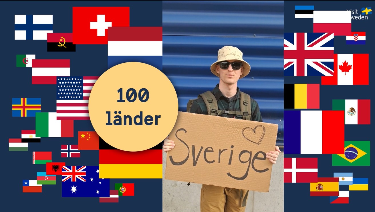 Man med skylt omges av olika länders falggor